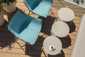 an overhead view of three chairs and a swimming pool at Radisson Blu Resort & Spa in Split