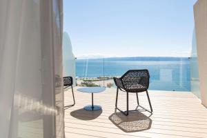 two chairs and a table on a balcony with the ocean at Radisson Blu Resort & Spa in Split
