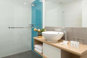 a bathroom with a sink, toilet and tub at Sails Port Macquarie by Rydges in Port Macquarie