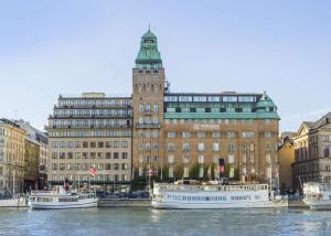 a large building with a clock tower on top of it at Radisson Collection, Strand Hotel, Stockholm in Stockholm