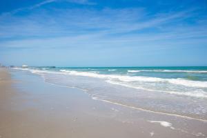 a beach with the ocean on a sunny day at Beach Vacation Condos in Myrtle Beach