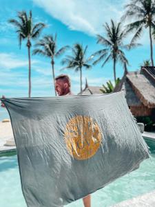 a man standing in the water in a swimming pool at Sea Love Beach Bar & Bungalows in Ban Tai