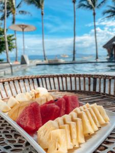 a tray of food on a table next to a pool at Sea Love Beach Bar & Bungalows in Ban Tai