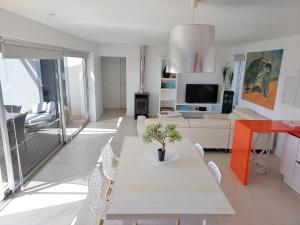 A television and/or entertainment centre at Private villa with pool in Lajares