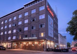 a building with a sign on the side of it at Scandic Hallandia in Halmstad