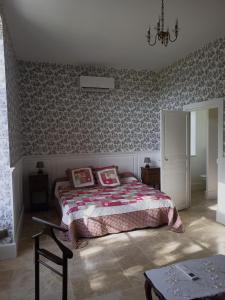 a bedroom with a bed and a table in it at CHATEAU DE CHAVANNES in Tresnay