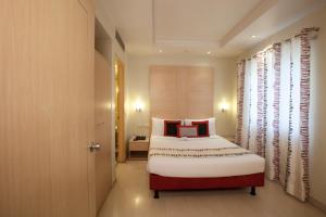 Letto o letti in una camera di Avalon Courtyard Residence Suites
