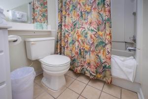 a bathroom with a toilet and a shower curtain at Beach Vacation Condos in Myrtle Beach