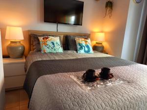 a bedroom with a bed with two mugs on it at CITY PREMIUM Studio Suite in Blankenberge