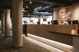 a lobby of a restaurant with a reception desk at Scandic Järva Krog in Solna