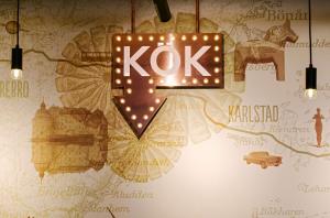 a kok sign hanging on a wall with lights at Scandic Uppsala Nord in Uppsala