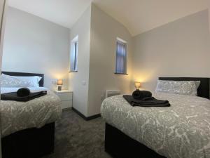 Ένα ή περισσότερα κρεβάτια σε δωμάτιο στο StayCrewe Apartments