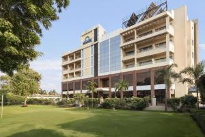 an office building with a lawn in front of it at Days Hotel Neemrana in Neemrana