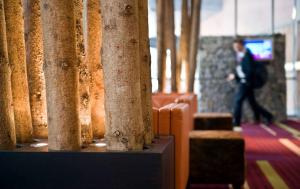 a man walking past a row of columns in a building at Wyndham Grand Salzburg Conference Centre in Salzburg