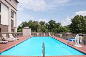 a large swimming pool with chairs at Wingate by Wyndham North Little Rock in North Little Rock