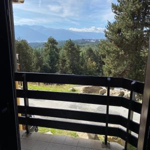 a view from a window of a fence at Les Myrtilles Pyrénées 2000 in Bolquere Pyrenees 2000