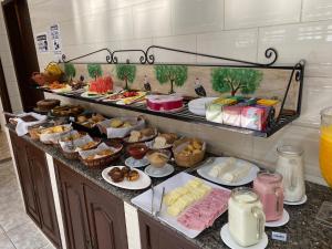 a buffet with many different types of food on a counter at Solar da Vila in Tiradentes