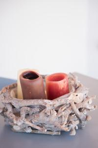 a wooden basket with two vases in it at Andria's suites in Chrissi Akti