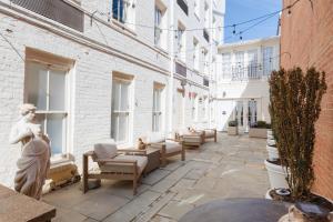 a courtyard with furniture and windows in a building at Sonder The Grace in Alexandria