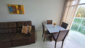 a living room with a couch and a table at Apto 2 Quartos I 2 Banheiros I Guarapari I Por do sol I Wi-Fi in Guarapari