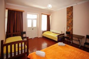 a small room with two beds and a table at Guest House Iaraji in Tʼianetʼi