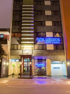 a building with a sign on the side of it at Los Mirtos suite & Hotel in Lima