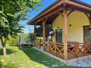 a house with a wooden gazebo at Guest House Marchini in Sapareva Banya