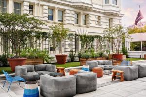 un grupo de sillas y mesas frente a un edificio en Generator Hotel Washington DC en Washington