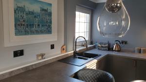 a kitchen with a sink and a counter top at Holiday Apartment, Balloch, Loch Lomond in Balloch