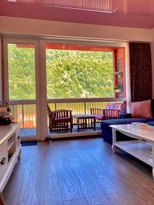 a living room with a couch and a table at Sweet Pink by Miro Apartment Early Checkin in Sinaia