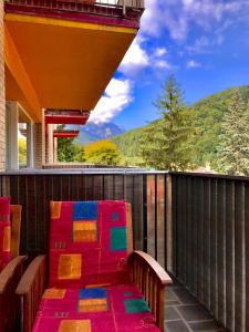 a balcony with a bench with a view of a mountain at Sweet Pink by Miro Apartment Early Checkin in Sinaia