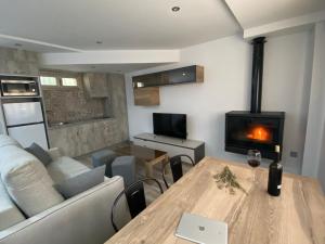 a living room with a table and a couch and a fireplace at CASA SUITE JTG in Alicante