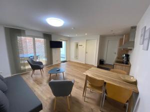 a living room with a wooden table and chairs at City Apartments in Erfurt