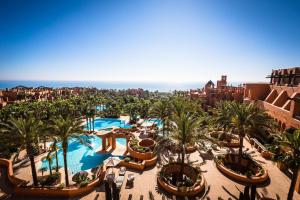 an aerial view of a resort with a pool and palm trees at Royal Hideaway Sancti Petri in Chiclana de la Frontera