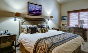 a bedroom with a large bed and two night stands at Bear Claw 508 - True Ski-in Ski-out Access, Slope Views & Winter Shuttle! in Steamboat Springs