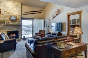 a living room with a couch and a fireplace at Bear Claw 508 - True Ski-in Ski-out Access, Slope Views & Winter Shuttle! in Steamboat Springs