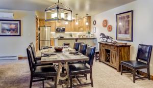 a kitchen and dining room with a table and chairs at Bear Claw 508 - True Ski-in Ski-out Access, Slope Views & Winter Shuttle! in Steamboat Springs