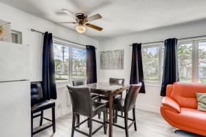 a dining room with a table and chairs and a ceiling fan at Tropical Getaway/ Stunning 2BR Gem in West Palm Beach