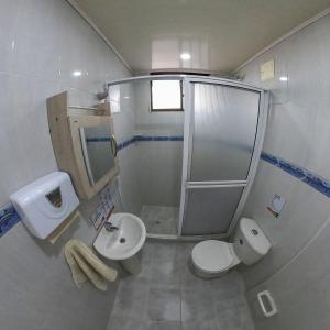 a bathroom with a shower and a toilet and a sink at Apartamentos Aury in San Andrés