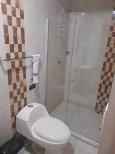 a bathroom with a toilet and a shower at Hostal Casa Mathias in Cartagena de Indias