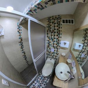 y baño con aseo, lavabo y escalera. en Apartamentos Aury en San Andrés