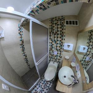 a bathroom with a toilet and a sink and a staircase at Apartamentos Aury in San Andrés