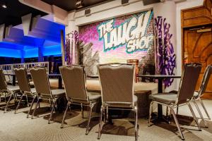 a room with chairs and a wall with graffiti at Hotel Blackfoot in Calgary