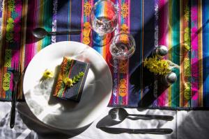 a table with a plate with a napkin and a plate with a napkin at Samay Kirutoa Lodge in Quilotoa