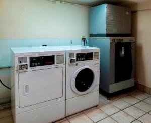 a washing machine and a washer in a kitchen at Red Roof Inn PLUS+ San Antonio Downtown - Riverwalk in San Antonio