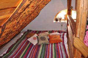 a bed with pillows on it in a room at Czarnotka in Mirsk