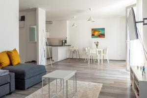een woonkamer met een bank en een tafel bij Amphora Luxury Apartment with FREE private Parking and cozy Balcony in Boedapest