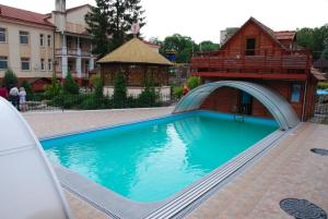 a swimming pool with a bridge over it at Filvarki-Centre in Kamianets-Podilskyi