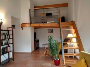 a room with a loft bed and a living room at Gîte Saint-Étienne-Lardeyrol, 3 pièces, 4 personnes - FR-1-582-332 in Saint-Étienne-Lardeyrol