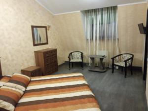 a hotel room with a bed and a table and chairs at готель ДежаВю in Berdychiv +19 photos